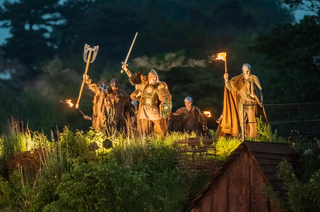 Viking holding lights and axes