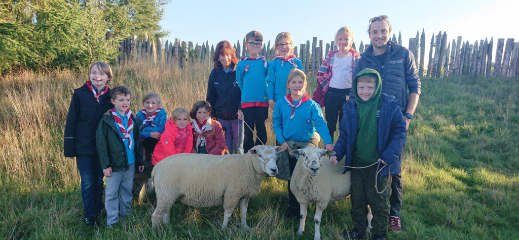 Stanhope Scouts with David Turner-Richardson and Karen Brass, members of Kynren's Animal Team, as well as Chesney and Oreo, two sheep in the Bishop Auckland production's animal cast