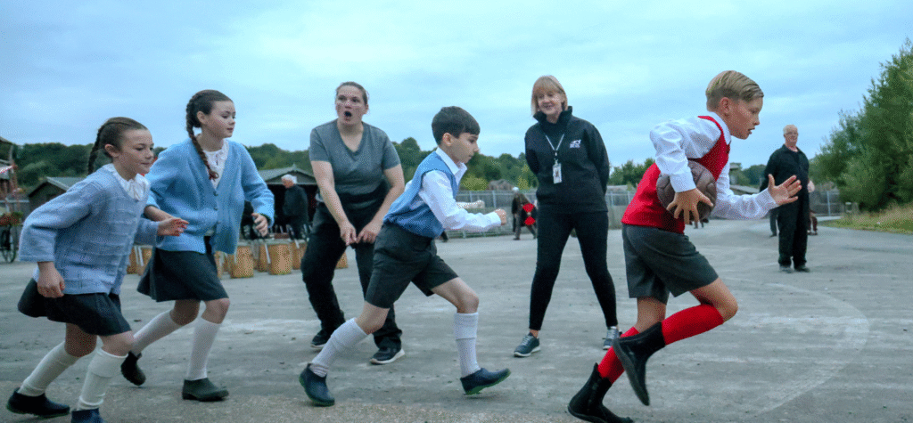 Children taking part in Kynren An Epic Tale of England, run to perform on stage