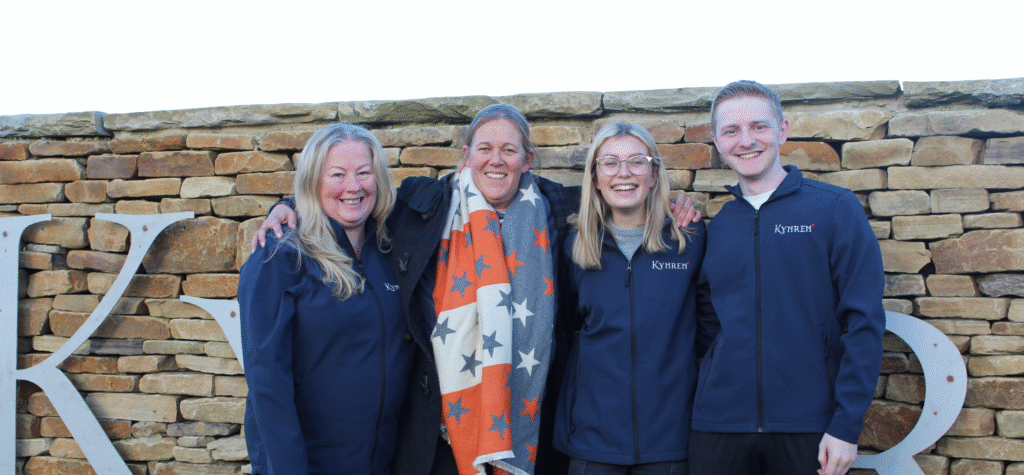 Kynren staff members hug and smile to camera