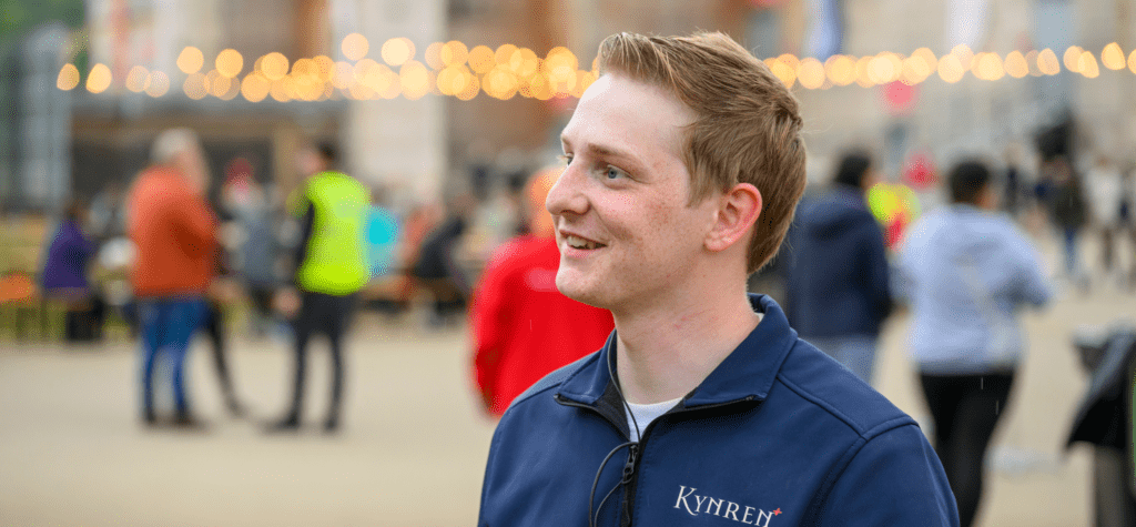 Jaden Dixon looks to the left of camera, with Kynren crowd behind him