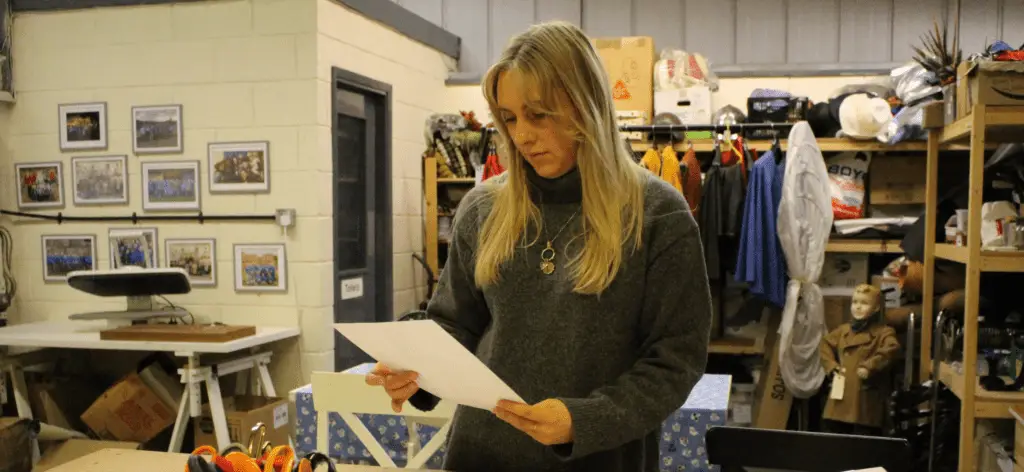 Emily reviews designs in a costume workshop