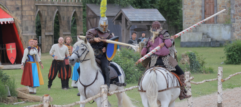 Two knights on horseback collide in a joust in The Trusty Steed, one of the shows in Kynren - The Storied Lands