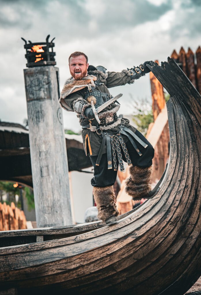 a viking stands on the bow of a longboat in one of Kynren - The Storied Lands' live action shows, Land of the Vikings